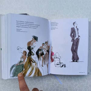 May include: An open book with a watercolour illustration of women in dresses and hats. The text on the page reads "As in fashion, Sophie Griotto's characteristic trait is perpetual movement. I love the graceful hip movements and elegant nonchalance of her women." Marlon Lahore 2011.