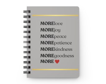 May include: A gray spiral bound notebook with a gold line and the words "MORElove", "MOREjoy", "MOREpeace", "MOREpatience", "MOREkindness", "MOREgoodness", and "MORE" with a red heart.