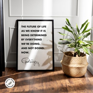 May include: Black and white framed print with a quote by Oprah Winfrey: "The future of life as we know it is being determined by everything we're doing. And not doing. Now."