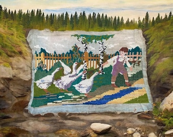 May include: A cross-stitch tapestry depicting a pastoral scene with a boy, geese, and a stream. The artwork features a boy in purple overalls, white geese, a wooden fence, and trees. The background shows a forest and a blue sky.