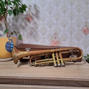 May include: A set of three ceramic mugs with a speckled, matte finish. The mugs are in shades of cream, light gray, and dark gray. Each mug has a simple, modern design and a rounded handle.