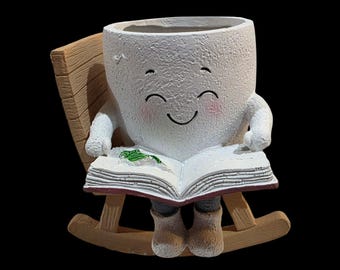 2.42L "Reading Egg" sitting in rocking chair with book