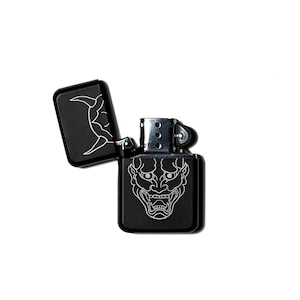 May include: Black lighter with a silver top and a black and white illustration of a Japanese demon on the front.