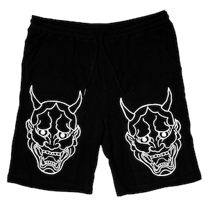 May include: Black cotton shorts with a white outline of a Japanese demon mask on each leg.