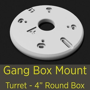 May include: A white, circular Gang Box Mount for a Turret, designed for a 4-inch round box. The mount features multiple holes and slots for mounting and cable management. The product is made of a solid, durable material.