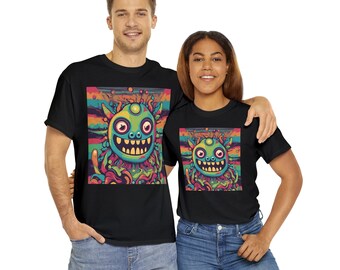 May include: Two black t-shirts with a colorful graphic print of a cartoon creature with three eyes and a wide smile. The creature is surrounded by colorful swirls and lines.