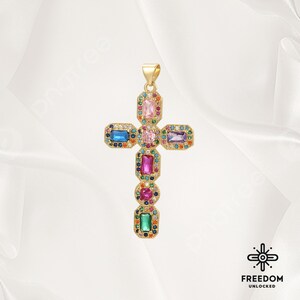 May include: A gold cross pendant with colorful rectangular gemstones. The cross is adorned with pink, blue, green, and purple stones.