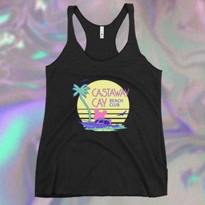 May include: Black tank top with a graphic of a boat, palm tree, and sunset. The graphic says "Castaway Cay Beach Club".