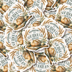 May include: A collection of stickers featuring a sourdough bread design. Each sticker has the text "Support Your Local Sourdough Dealer" in a circular design with wheat stalks and a loaf of bread, a knife, and a small jar.