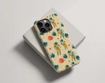May include: A phone case featuring a repeating pattern of astronauts, planets, and red dots on a cream background. The astronauts are yellow and blue. The case has a camera cutout.