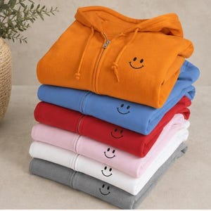 Embroidered Chest Graphic Hoodie Smiley Face Design Men Zip Sweatshirt Casual Comfort Wear Minimalist Style Everyday Essential Adjustable Hood Zipper Front Pocket Jacket Cozy Outerwear Year Round Layering Unisex Apparel Simple Smile Happy Unisex Men or Women Zippered Hoodie