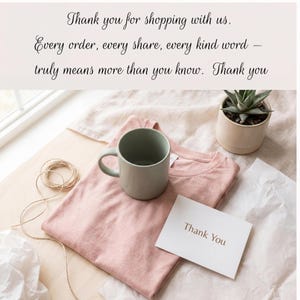 May include: A flat lay arrangement with a pink t-shirt, a green mug, and a small succulent in a beige pot. A white card with "Thank You" is present. The image includes the text "Thank you for shopping with us."