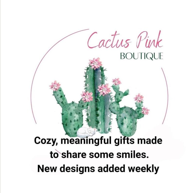 May include: A watercolour illustration of green cacti with pink flowers and a white cat. The text reads "Cactus Pink Boutique" and "Cozy, meaningful gifts made to share some smiles. New designs added weekly."