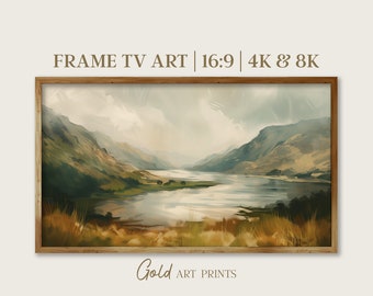 May include: A framed painting of a lake surrounded by mountains. The painting is in a muted color palette of greens, browns, and blues. The text "FRAME TV ART | 16:9 | 4K & 8K" is at the top of the image. The text "Gold ART PRINTS" is at the bottom of the image.