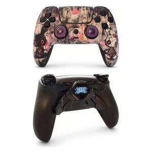 May include: A wireless game controller featuring a custom graphic shell with black, white, and pink abstract patterns and cartoon character illustrations. The back view shows a black attachment with a small digital screen displaying the number 1.