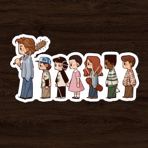 May include: A sticker featuring a line of cartoon characters, each with unique outfits and hairstyles. The first character holds a bat with nails. The characters are in a row, with a brown wooden background.