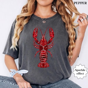 woman wearing comfort colors lobster shirt with red sparkle lobster graphic