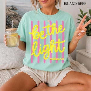 Bible verse t-shirt for women featuring Be the Light design.