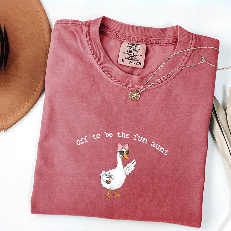 Whimsical goose graphic wearing bow and sunglasses holding iced coffee printed on t shirt for aunt gift.