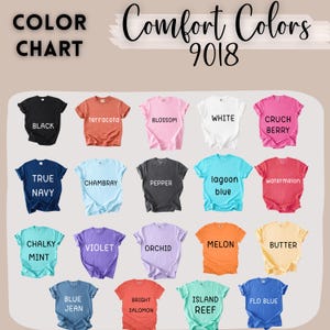 May include: A color chart for Comfort Colors 9018 t-shirts displaying 19 short-sleeve shirts in various colors including black, terracotta, blossom, white, crunch berry, true navy, chambray, pepper, lagoon blue, watermelon, chalky mint, violet, orchid, melon, butter, blue jean, bright salomon, island reef, and flo blue.