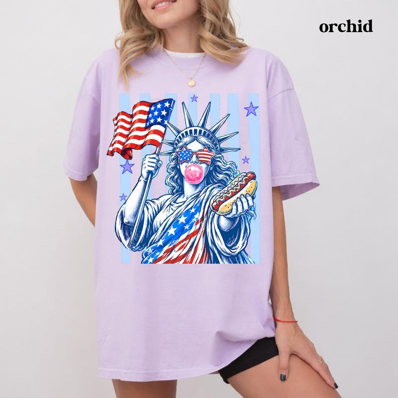 USA 250th anniversary tee with Statue of Liberty holding a hot dog and American flag.