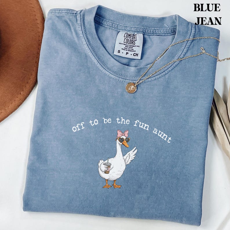 Funny goose illustration wearing sunglasses and bow holding a drink printed on comfort colors style t shirt for aunt gif