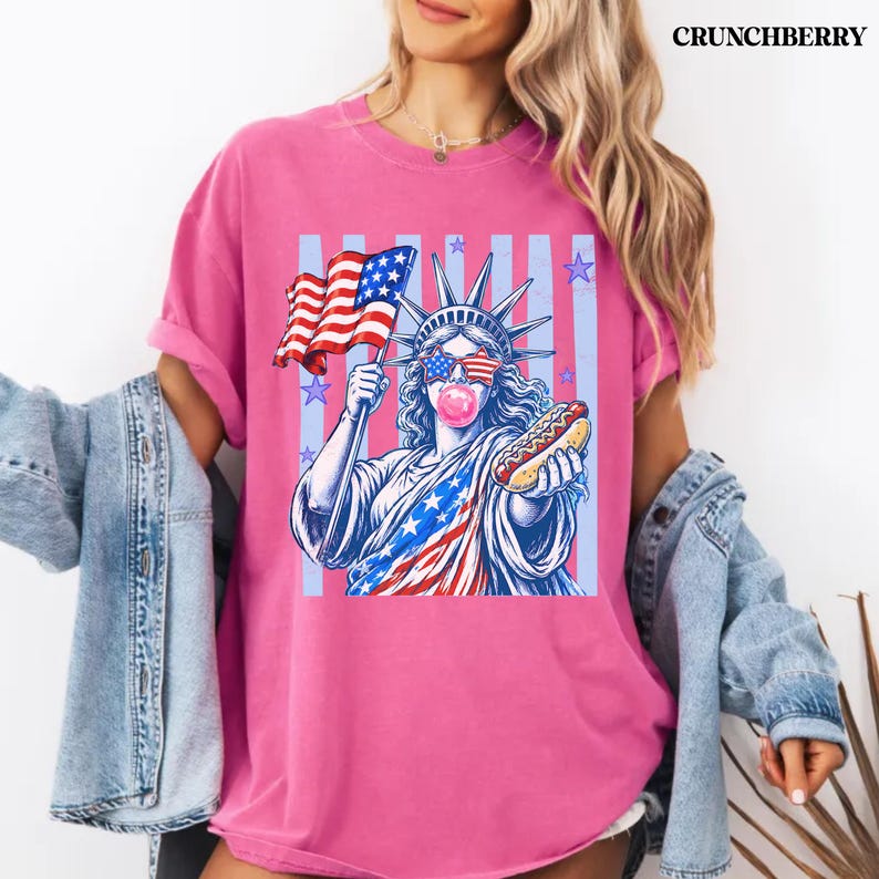Trendy patriotic women shirt with preppy Statue of Liberty hot dog graphic.