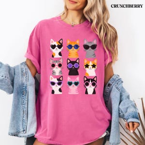 Colorful cat graphic tee for women and cat enthusiasts.
Funny feline t-shirt with bright and cheerful cat artwork.
Pet lover shirt featuring colorful kitty character design.