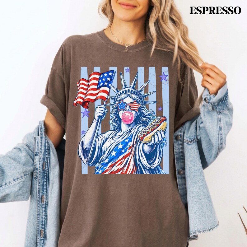 Trendy 4th of July apparel with Statue of Liberty, stars, stripes, and hot dog.