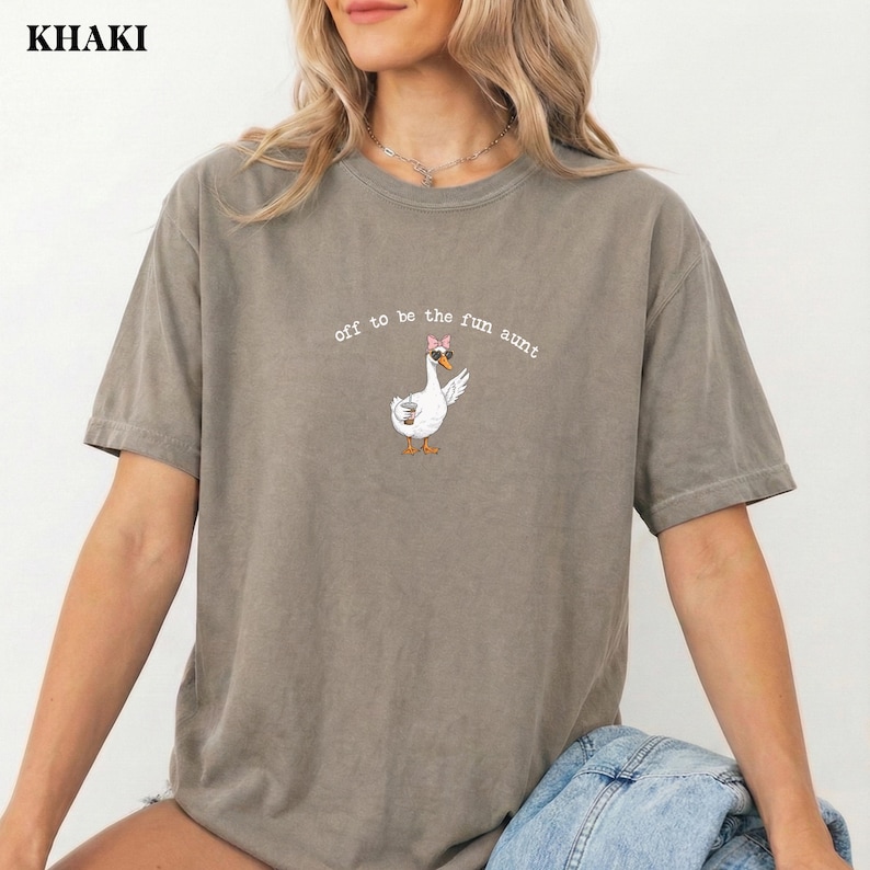 Cute trendy goose graphic with bow sunglasses and drink printed on t shirt.