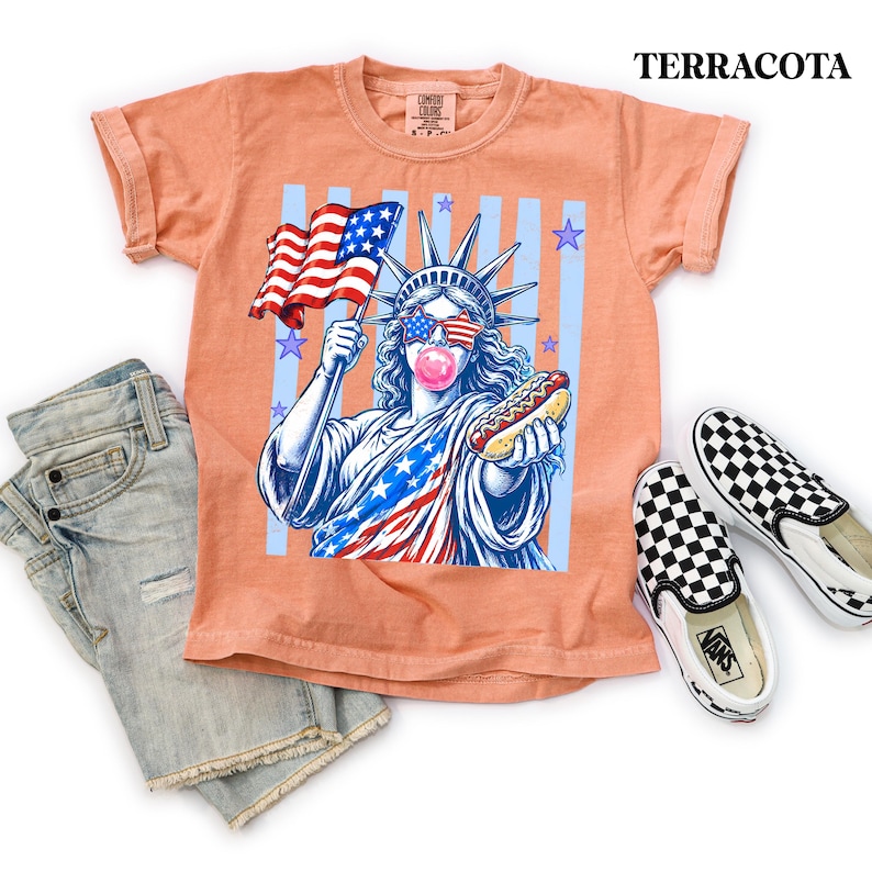 Red white and blue Fourth of July tee with fun Statue of Liberty hot dog design.