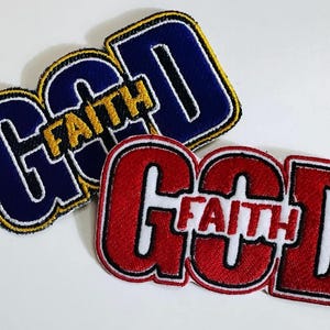 May include: Two embroidered patches with the word "GOD" in large, bold letters. The word "FAITH" is written in smaller letters across the top of the word "GOD". One patch is navy blue with yellow trim and the other is red with white trim.