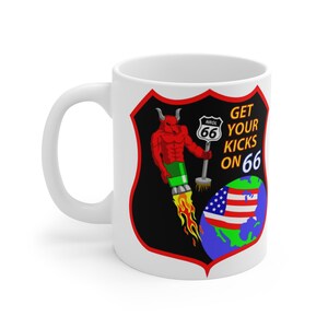 May include: White ceramic mug with a red, black, and green graphic of a devil holding a Route 66 sign. The text "GET YOUR KICKS ON 66" is printed on the mug.
