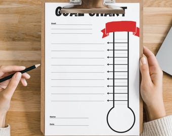 May include: A clipboard holds a white "GOAL CHART" sheet with a thermometer graphic and a red banner. The chart has lines for goals, name, and date. A hand holds a pencil, and another hand holds the clipboard.