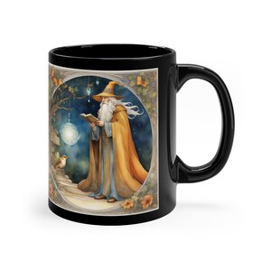 May include: Black ceramic mug featuring a white wizard reading a book in a woodland scene. The wizard is wearing a blue robe and a yellow cloak. A small bird is perched on a branch behind the wizard.