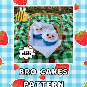 May include: Two crocheted Finn the Human characters from Adventure Time, in blue and white, sitting in a wicker basket on a green and white checkered picnic blanket. The text "BRO! CAKES" is in a speech bubble above the basket.