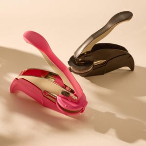 May include: Two desk seals, one pink and one black, are displayed on a light background. The pink seal has a gold-colored interior and the text "Floral Seal". The black seal has a silver-colored interior.