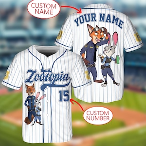 May include: White baseball jersey with blue pinstripes featuring the word "Zootopia" and the number 15. The jersey has cartoon images of Nick Wilde and Judy Hopps. The back of the jersey has the text "YOUR NAME".