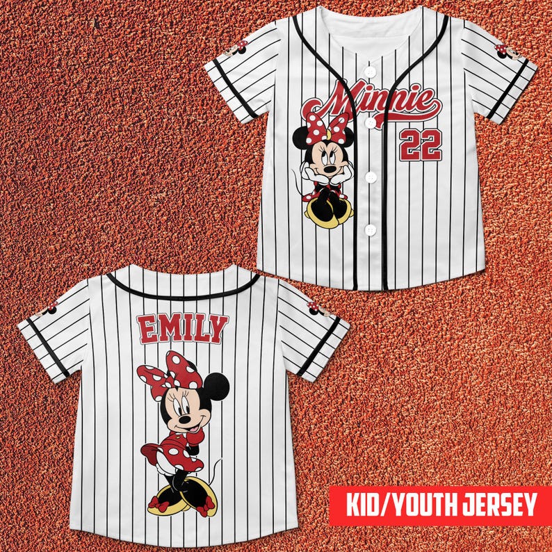 May include: White and black pinstripe baseball jersey featuring Minnie Mouse. The front displays "Minnie" in red script, the number 22, and a Minnie Mouse graphic. The back of the jersey has the name "EMILY" and another Minnie Mouse graphic. The text "KID/YOUTH JERSEY" is in a red box.