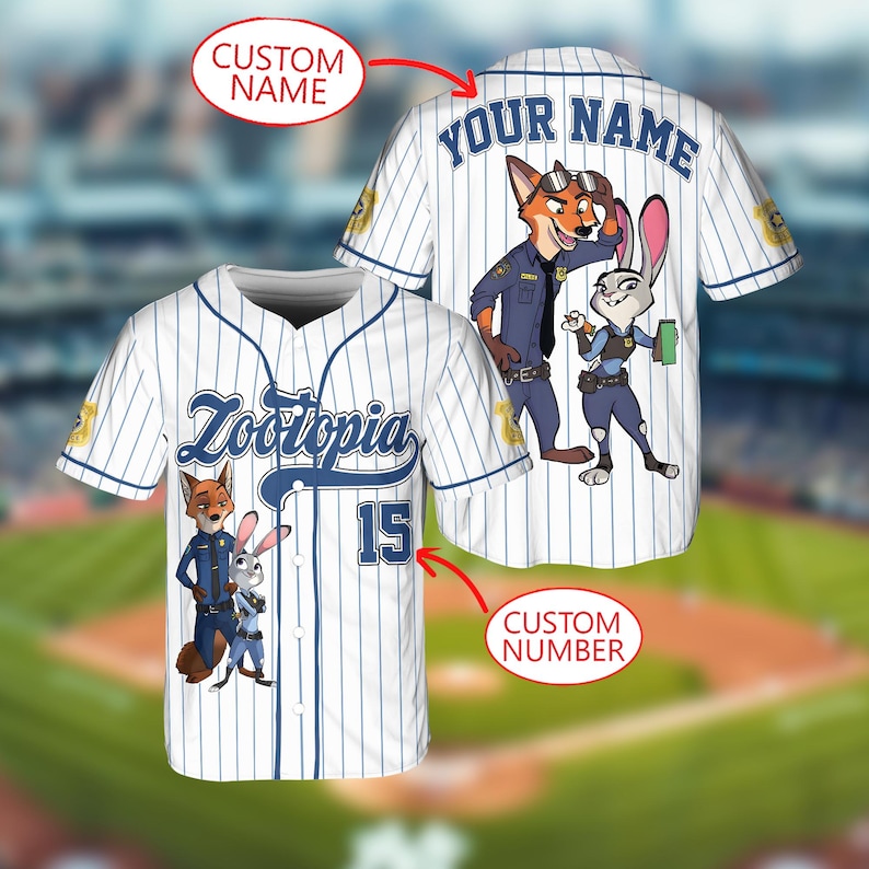 May include: White baseball jersey with blue pinstripes featuring the word "Zootopia" and the number 15. The jersey has cartoon images of Nick Wilde and Judy Hopps. The back of the jersey has the text "YOUR NAME".