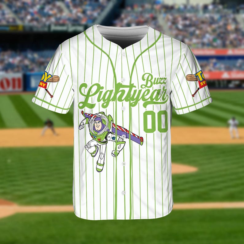 May include: White baseball jersey with green pinstripes and accents. Features the text "Buzz Lightyear" in green script, the number "00", and a graphic of Buzz Lightyear. Includes "Toy Story" logo on the sleeves.