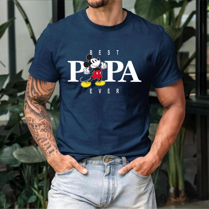 May include: A navy blue t-shirt with a white graphic of Mickey Mouse and the text "BEST PAPA EVER".