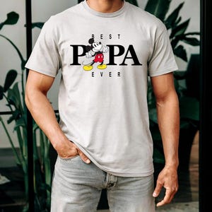May include: A gray t-shirt with a black and white illustration of Mickey Mouse and the text "BEST PAPA EVER".