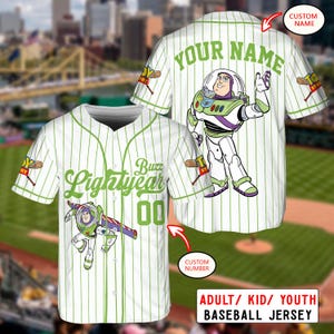 May include: White baseball jersey with green pinstripes and Buzz Lightyear graphics. The jersey features the text "Buzz Lightyear" and "00" on the front, and "YOUR NAME" on the back. The jersey is available in adult, kid, and youth sizes.