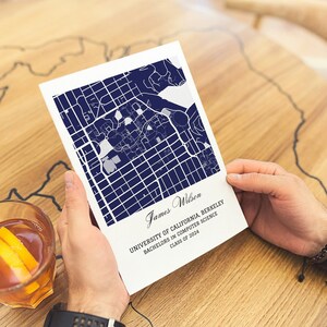 May include: A white card with a blue map of the University of California, Berkeley campus. The card reads "James Wilson, University of California, Berkeley, Bachelors in Computer Science, Class of 2024".