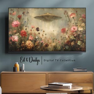 May include: A digital painting of a field of flowers with a flying saucer hovering above. The saucer is emitting a beam of light. The painting is in a modern TV frame. Ed & Dustys | Digital TV Collection is written below the frame.
