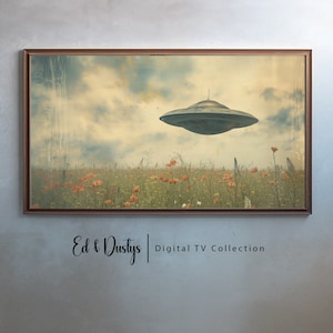 May include: A vintage-style image of a flying saucer hovering over a field of red poppies. The image has a faded, retro look and is framed in a brown wood frame. The text "Ed & Dustys | Digital TV Collection" is printed below the image.