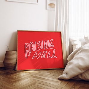 May include: A red framed poster with the text "Raising Hell" in white outlined lettering.