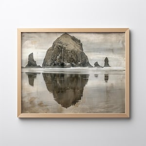 May include: A framed photograph of a large rock formation jutting out of the ocean, with a reflection of the rock in the water. The sky is cloudy and the water is calm.