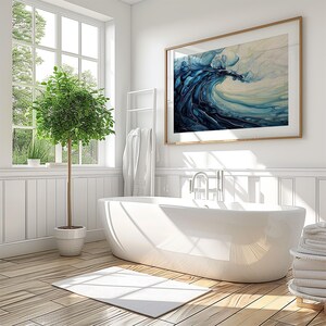 a bathroom with a large white bathtub next to a potted plant